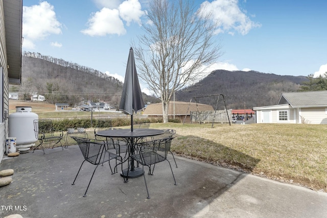 view of patio / terrace featuring a mountain view and outdoor dining area