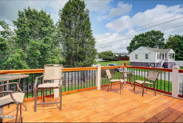 wooden deck featuring a yard