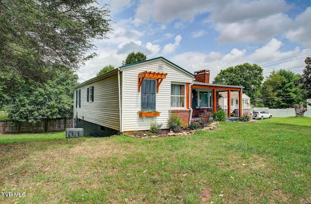 view of front of property with a front yard and central air condition unit