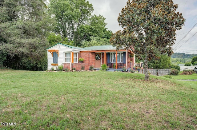 view of front of home with a porch and a front lawn