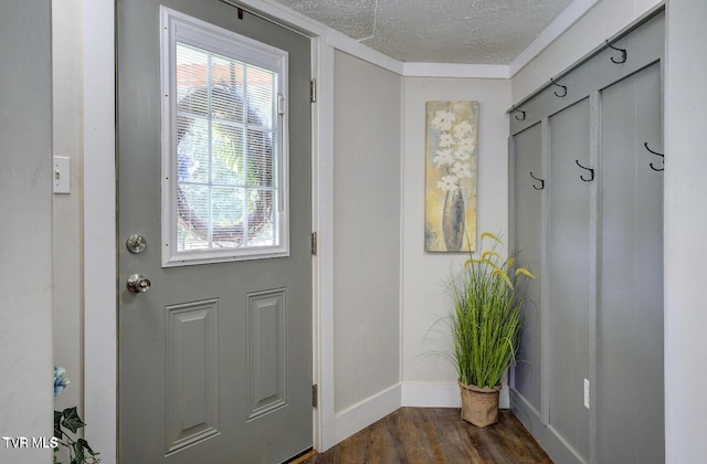 entryway featuring dark wood-type flooring and a textured ceiling