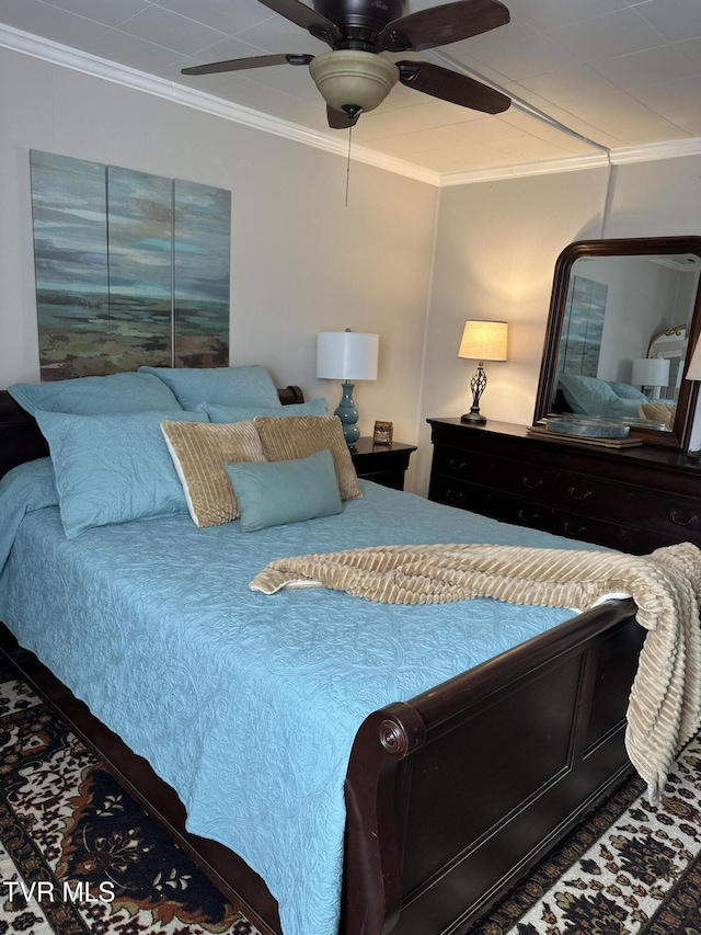 bedroom with ornamental molding and ceiling fan