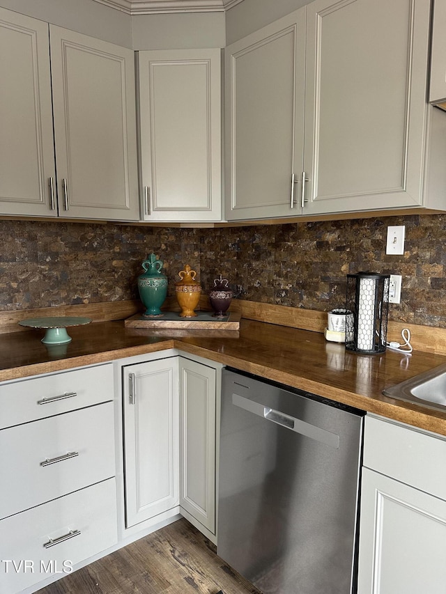 kitchen with hardwood / wood-style flooring, dishwasher, butcher block counters, white cabinetry, and tasteful backsplash