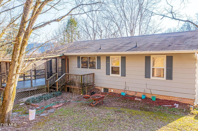 view of front of property featuring a sunroom and a deck