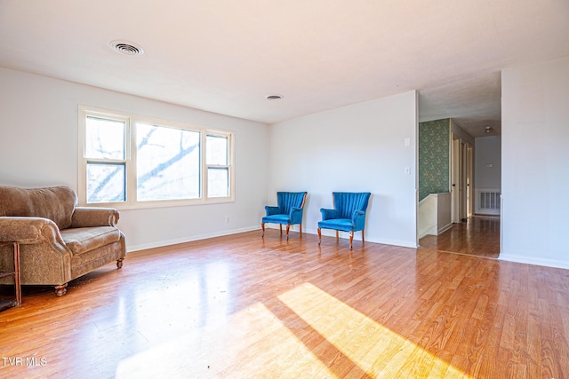 living area with hardwood / wood-style floors