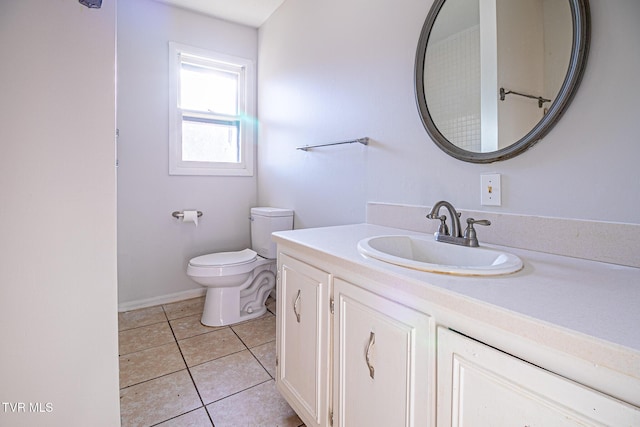 bathroom with vanity, toilet, and tile patterned flooring