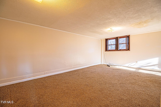 spare room with carpet flooring and a textured ceiling