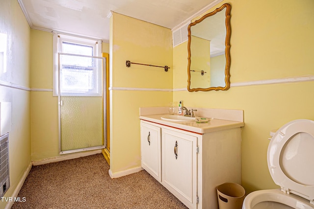 bathroom with vanity, a shower with shower door, and toilet