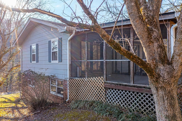 view of property exterior featuring a sunroom