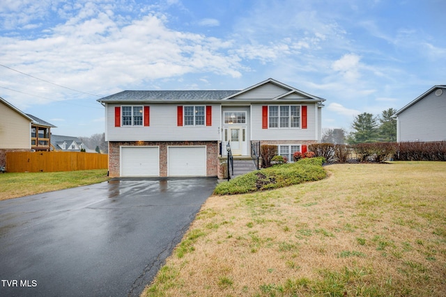 bi-level home with a garage and a front yard