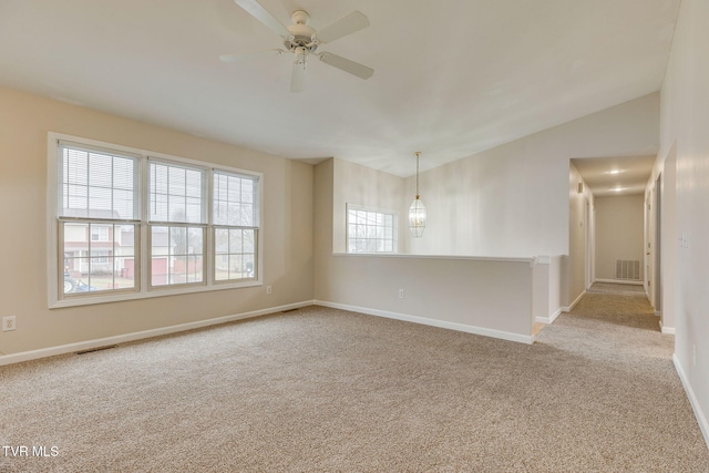 unfurnished room with lofted ceiling, light colored carpet, and ceiling fan