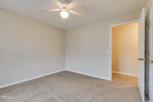 carpeted empty room featuring ceiling fan