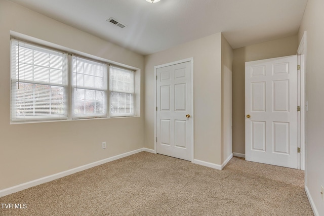 unfurnished bedroom featuring light colored carpet