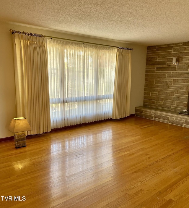 spare room with wood-type flooring and a textured ceiling