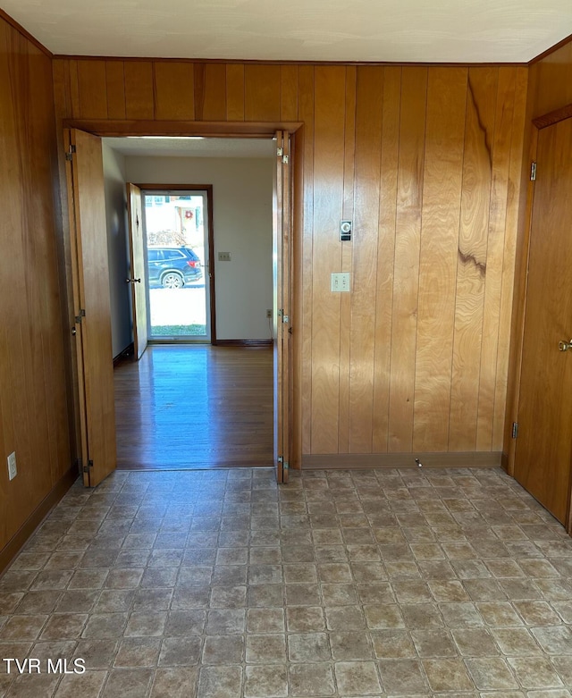 hallway featuring wooden walls