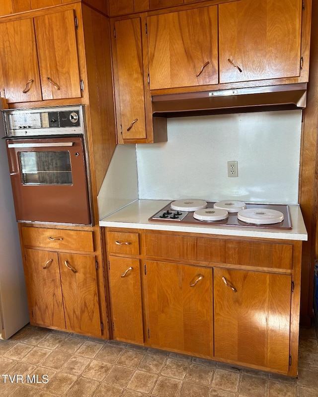 kitchen with wall oven and stovetop