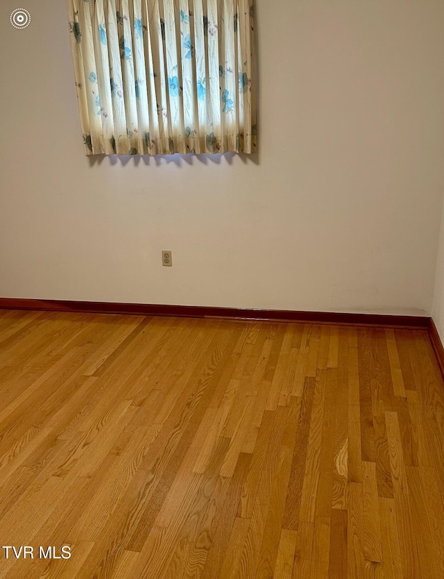 empty room with light hardwood / wood-style flooring