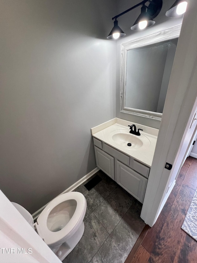 bathroom featuring vanity and toilet