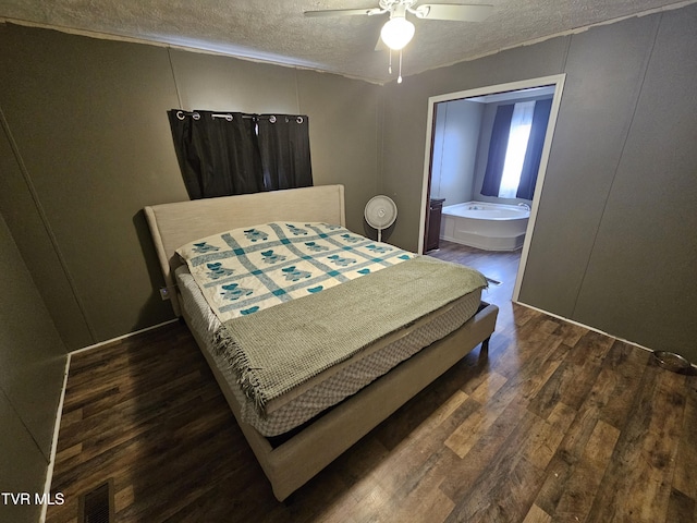 bedroom featuring ceiling fan, dark hardwood / wood-style floors, and a textured ceiling