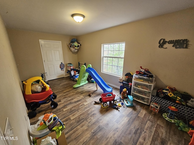 recreation room with dark hardwood / wood-style flooring