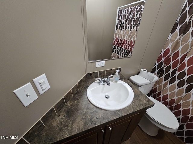 bathroom featuring vanity and toilet