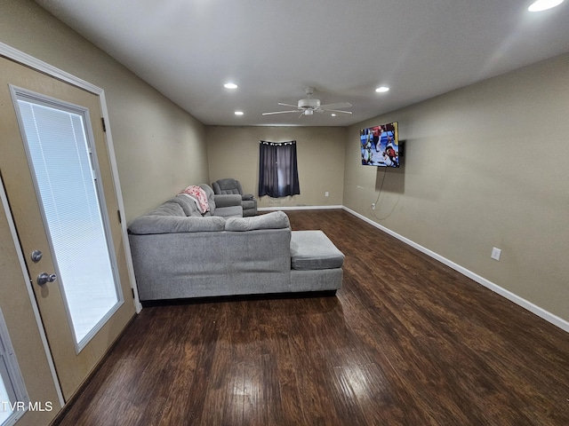 living room featuring dark hardwood / wood-style flooring and ceiling fan