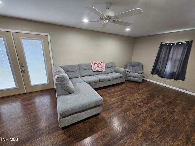 living room with dark hardwood / wood-style floors, french doors, and ceiling fan