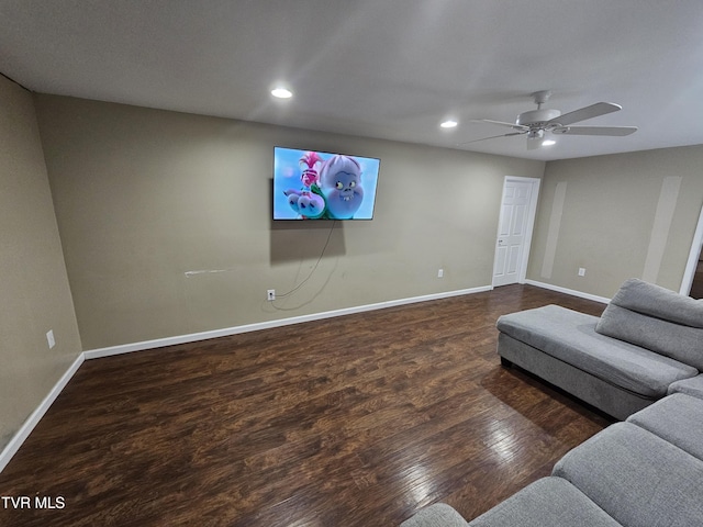 living room with dark wood-type flooring and ceiling fan