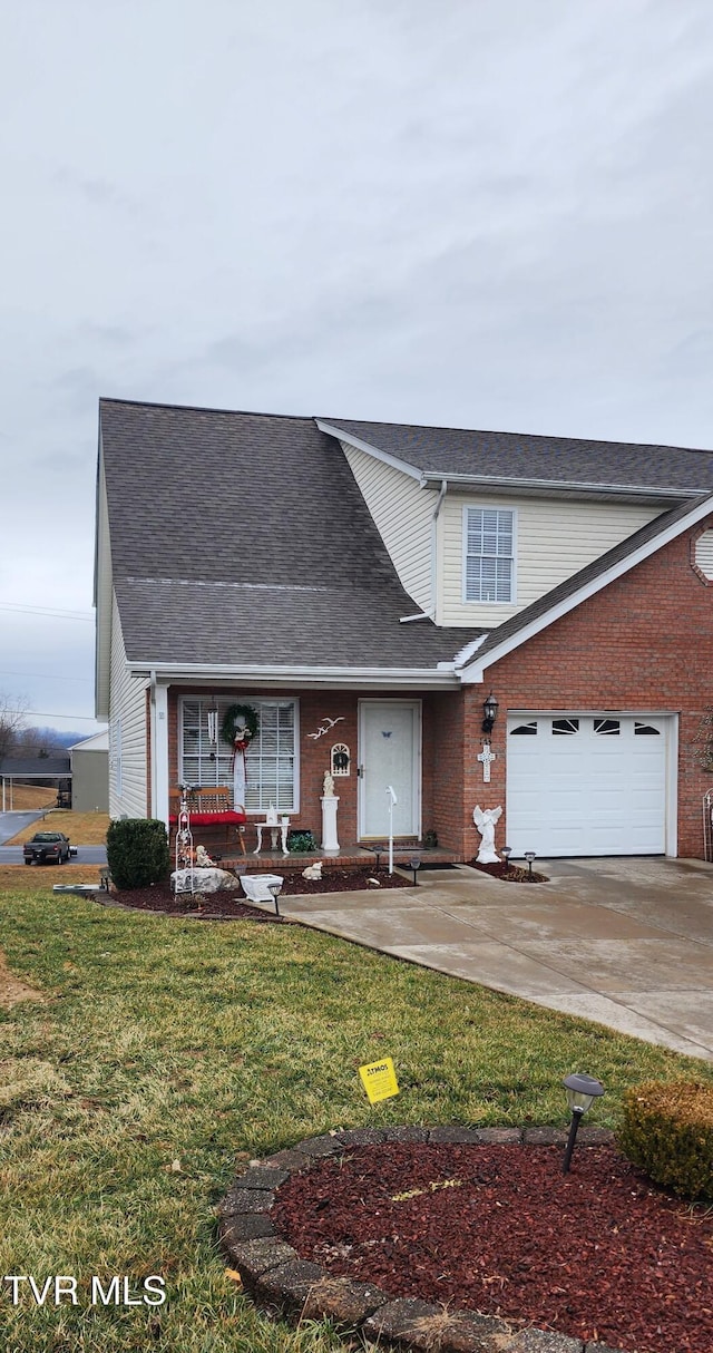 view of property featuring a garage and a front lawn