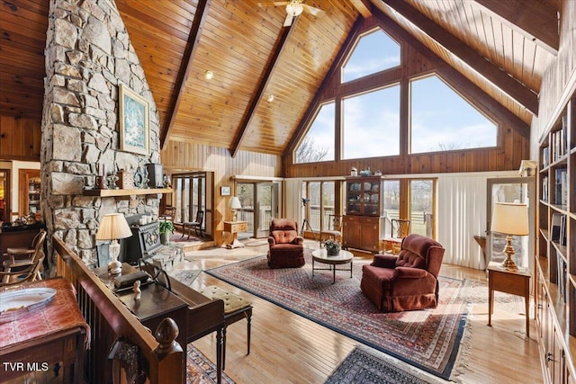 living room with beamed ceiling, wooden ceiling, and light hardwood / wood-style flooring