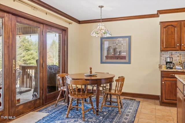 dining area featuring crown molding and light tile patterned flooring