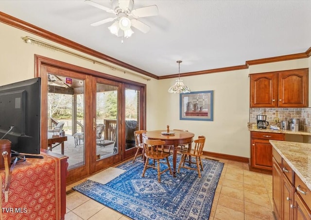 tiled dining area featuring ornamental molding and ceiling fan