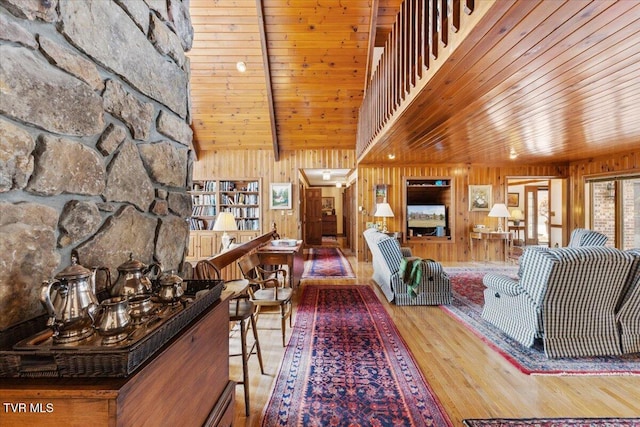 living room with wood-type flooring, wooden walls, and wooden ceiling