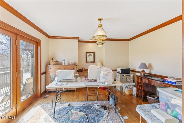 office area featuring hardwood / wood-style flooring, crown molding, and an inviting chandelier