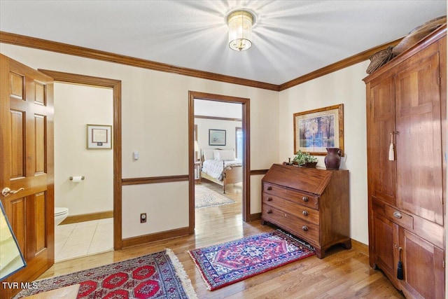 hallway with crown molding and light hardwood / wood-style floors