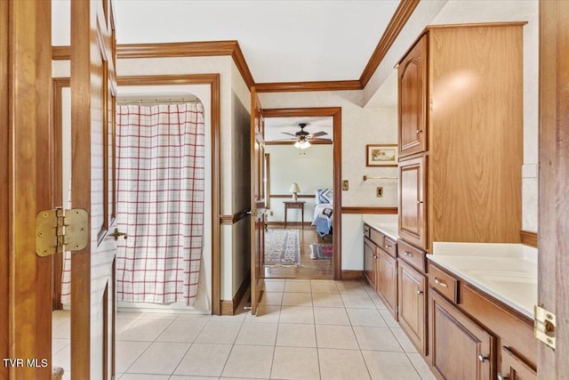 bathroom featuring tile patterned flooring, vanity, ornamental molding, and ceiling fan