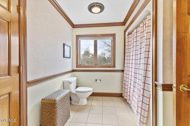 bathroom with crown molding, tile patterned floors, and toilet