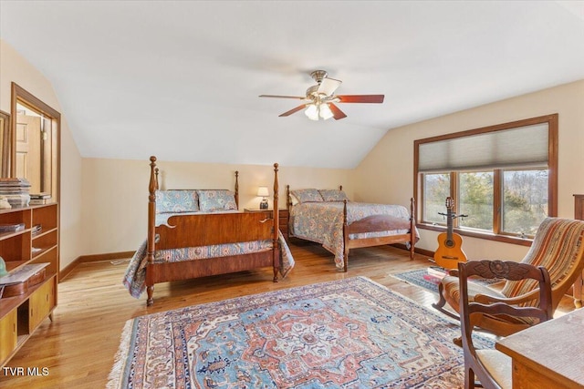 bedroom featuring ceiling fan, lofted ceiling, and light hardwood / wood-style flooring