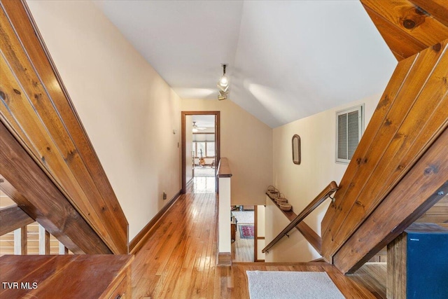 corridor featuring lofted ceiling and light hardwood / wood-style floors