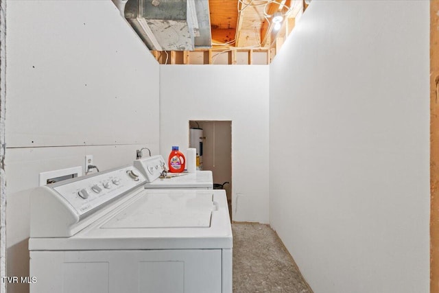 clothes washing area featuring washer and clothes dryer