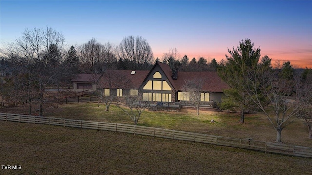 view of front facade featuring a rural view and a lawn