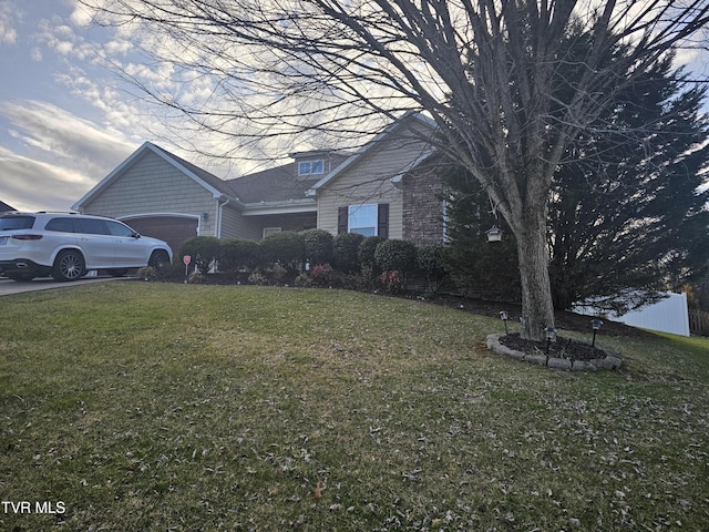 view of side of home with a garage and a lawn