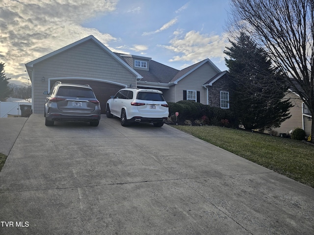 view of front of house with a garage and a front lawn