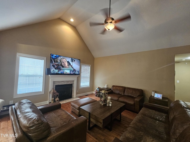 living room with hardwood / wood-style flooring, high vaulted ceiling, and ceiling fan