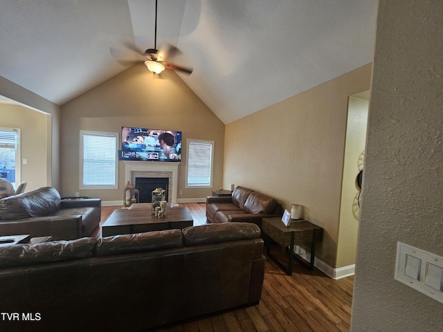 living room with hardwood / wood-style flooring, ceiling fan, and lofted ceiling