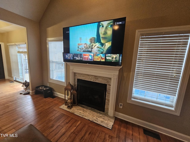 living room with hardwood / wood-style flooring and lofted ceiling