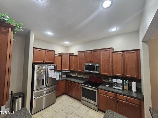 kitchen with stainless steel appliances and light tile patterned floors