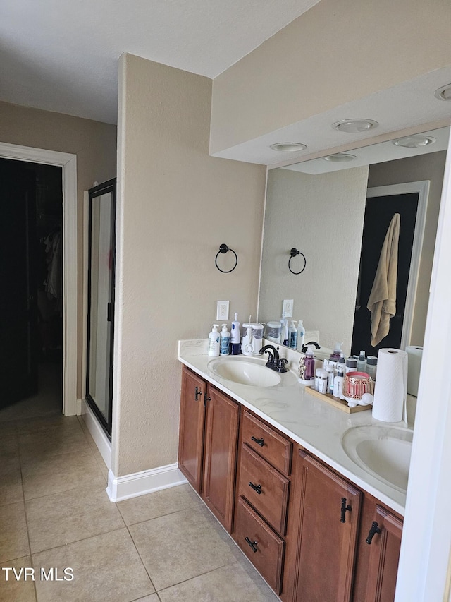 bathroom featuring vanity, tile patterned floors, and walk in shower