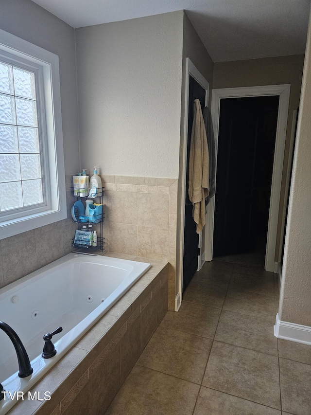 bathroom featuring tiled bath and tile patterned floors