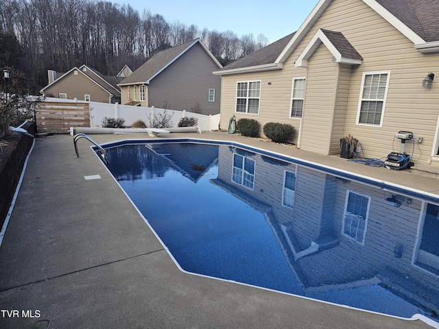 view of pool with a diving board